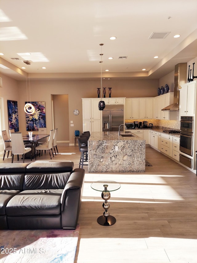 living room with sink and light hardwood / wood-style floors