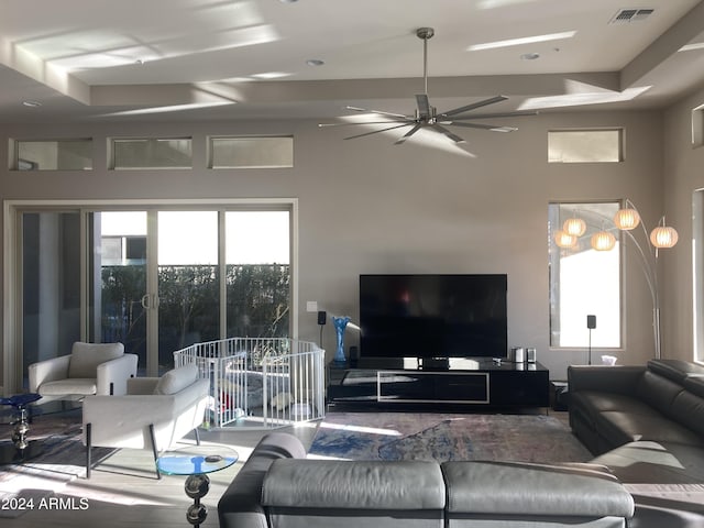 living room featuring ceiling fan and a healthy amount of sunlight