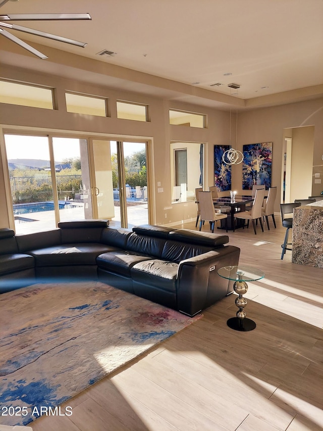 living room featuring ceiling fan and light hardwood / wood-style flooring