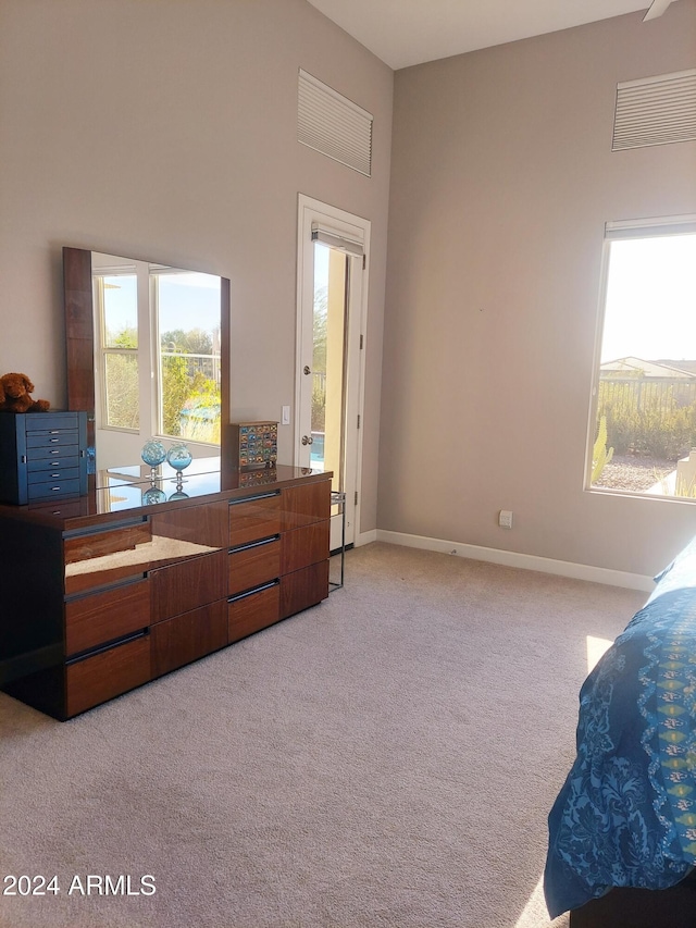 carpeted bedroom featuring multiple windows