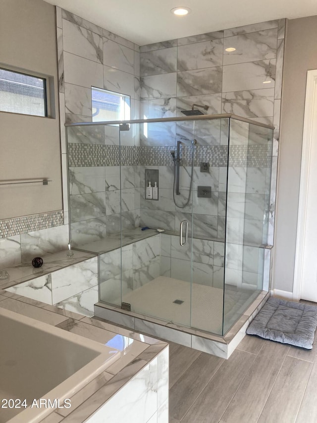 bathroom with separate shower and tub