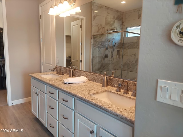 bathroom with vanity, wood-type flooring, and an enclosed shower