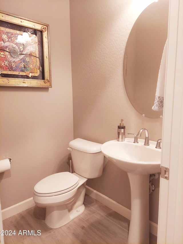 bathroom featuring hardwood / wood-style floors and toilet