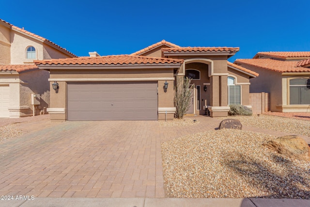 mediterranean / spanish-style home with a garage