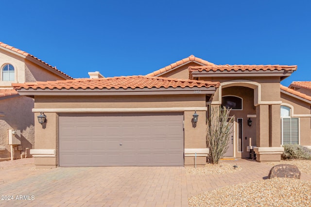 mediterranean / spanish-style home featuring a garage