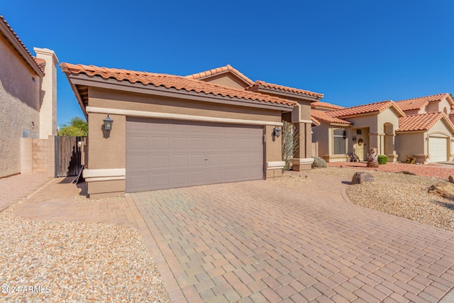 mediterranean / spanish-style home with a garage