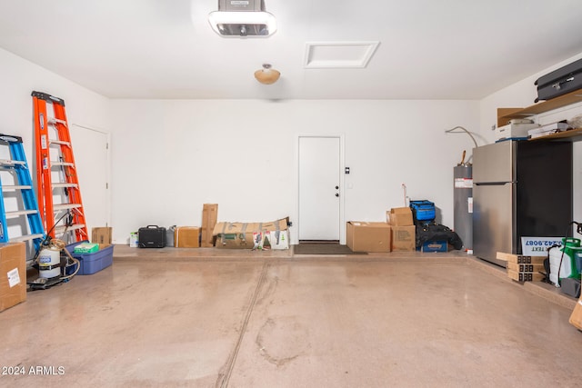 garage featuring stainless steel refrigerator, water heater, and a garage door opener