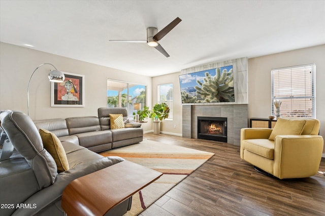 4563 E Libby St, Phoenix, AZ 85032 - living room featuring a ceiling fan, wood finished floors, and a tiled fireplace