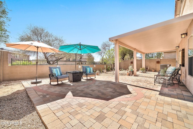 view of patio with a fire pit and a fenced backyard