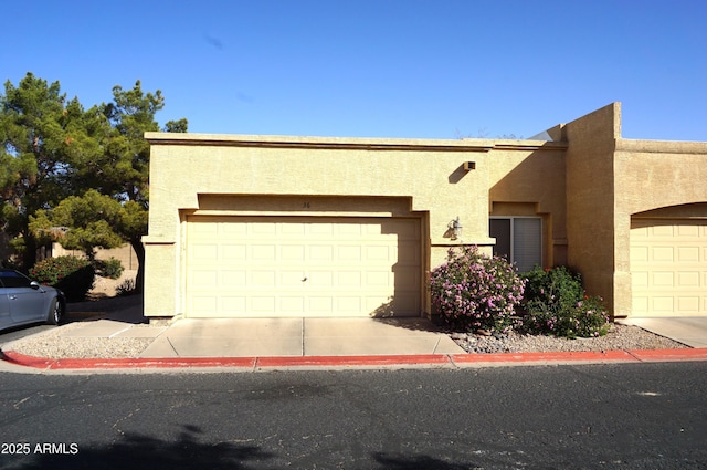 townhome / multi-family property featuring an attached garage and stucco siding