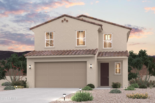 view of front of house featuring a garage, driveway, and stucco siding