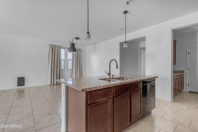 kitchen featuring a kitchen island with sink, sink, black dishwasher, decorative light fixtures, and light stone counters