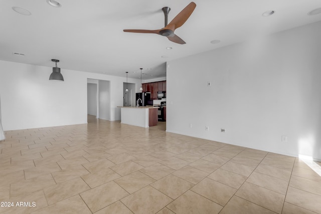 unfurnished living room featuring ceiling fan and light tile patterned flooring