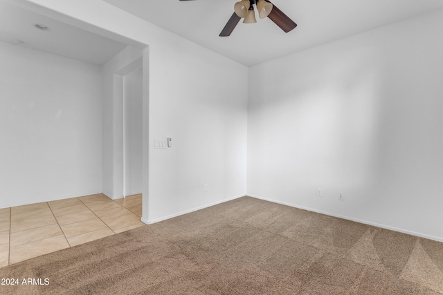 carpeted empty room featuring ceiling fan