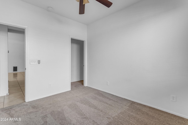 unfurnished bedroom featuring ceiling fan and light colored carpet