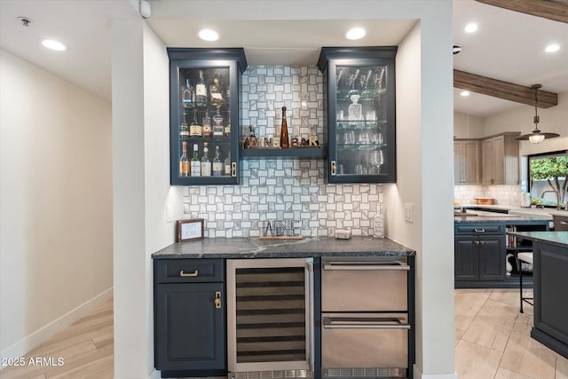 bar featuring backsplash, baseboards, wine cooler, beam ceiling, and wet bar