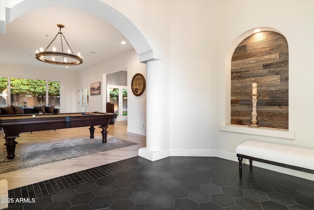 interior space with billiards, baseboards, recessed lighting, arched walkways, and a chandelier