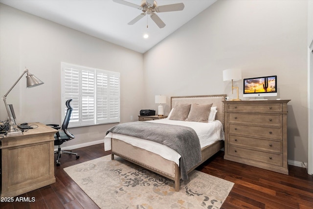 bedroom with ceiling fan, dark wood-type flooring, baseboards, and vaulted ceiling