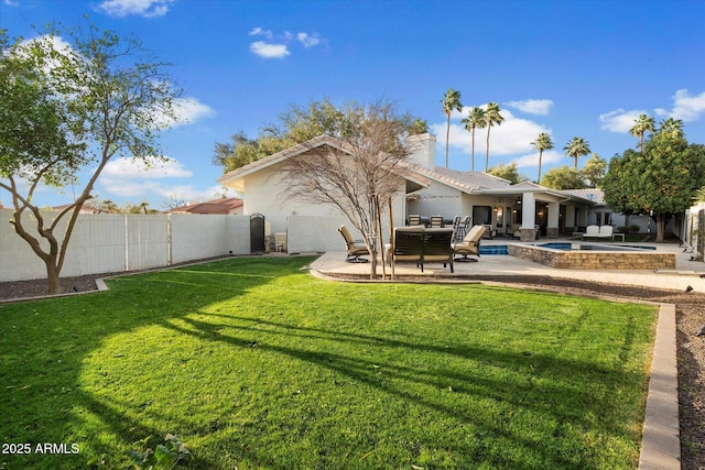 rear view of house with a patio, a fenced in pool, a yard, a fenced backyard, and stucco siding