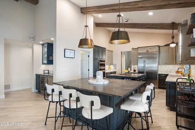 kitchen with decorative backsplash, visible vents, a spacious island, and stainless steel appliances