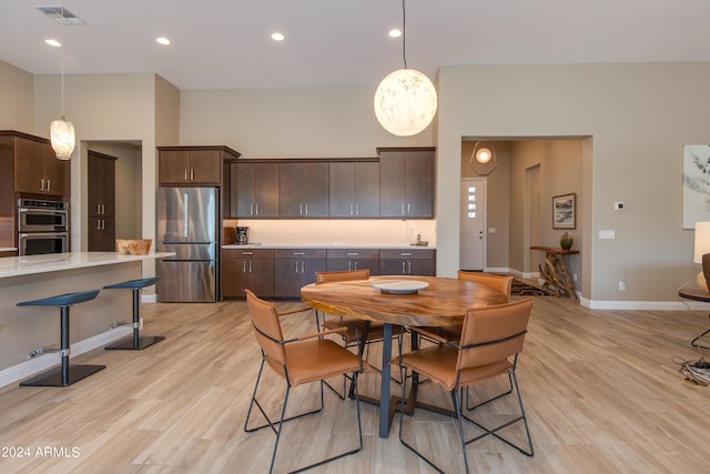 dining area featuring light wood-type flooring, baseboards, visible vents, and recessed lighting