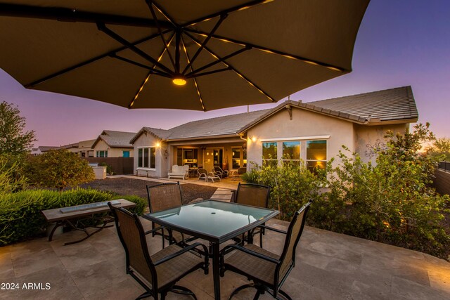 view of patio terrace at dusk