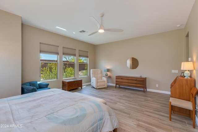 bedroom with light wood-type flooring, visible vents, baseboards, and a ceiling fan