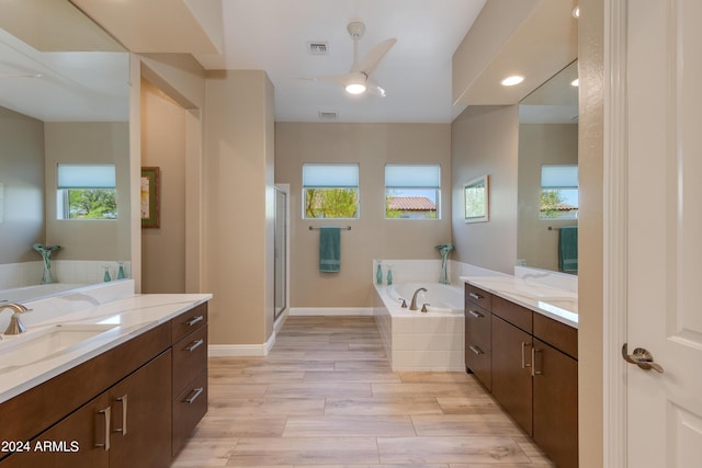 bathroom with two vanities, visible vents, a sink, a shower stall, and a bath