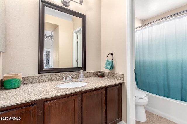 full bathroom featuring ceiling fan, vanity, shower / bath combination with curtain, tile patterned floors, and toilet