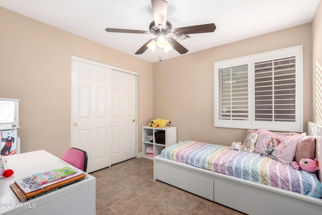 tiled bedroom with a closet and ceiling fan