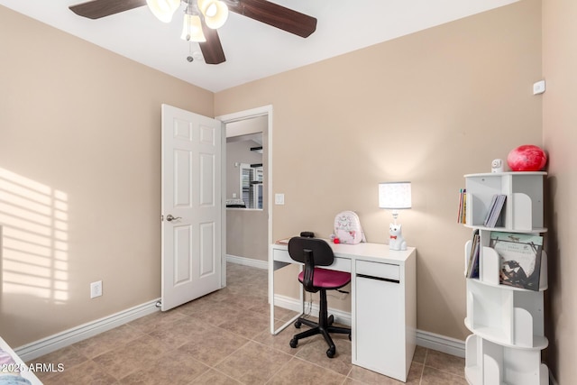 home office with light tile patterned floors and ceiling fan