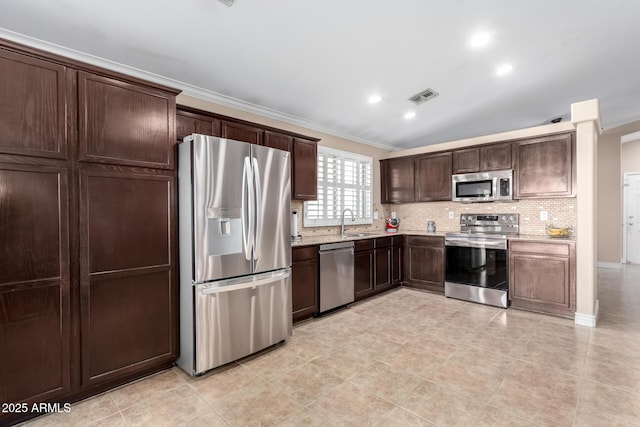 kitchen with stainless steel appliances, ornamental molding, sink, and decorative backsplash