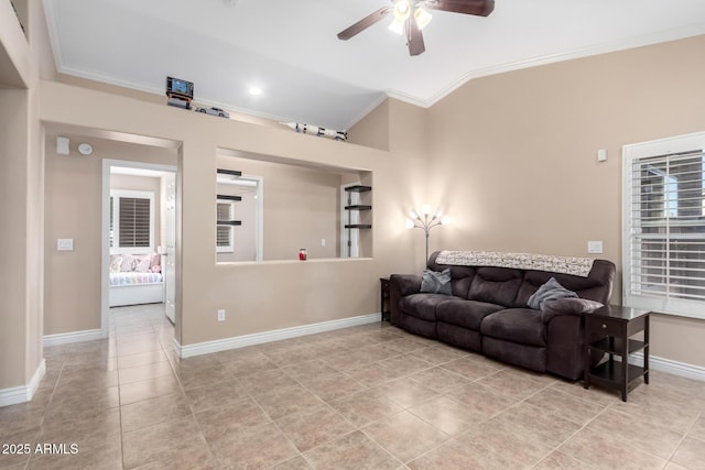 tiled living room featuring ceiling fan, lofted ceiling, and ornamental molding