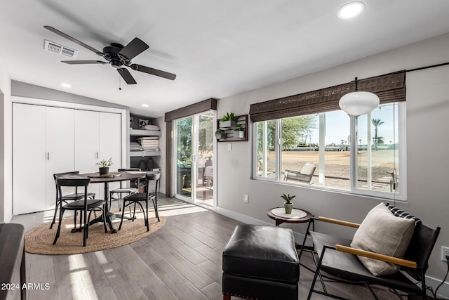 dining area with hardwood / wood-style flooring, vaulted ceiling, and ceiling fan