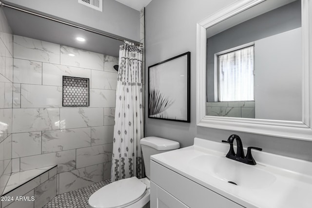 bathroom with a shower with curtain, vanity, and toilet