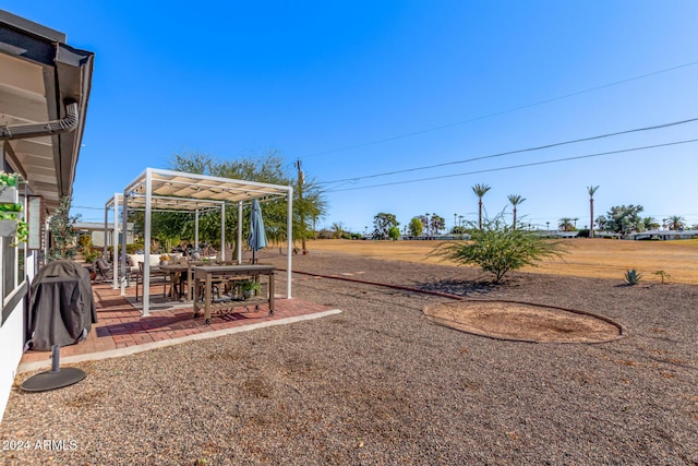 view of yard with a pergola and a patio