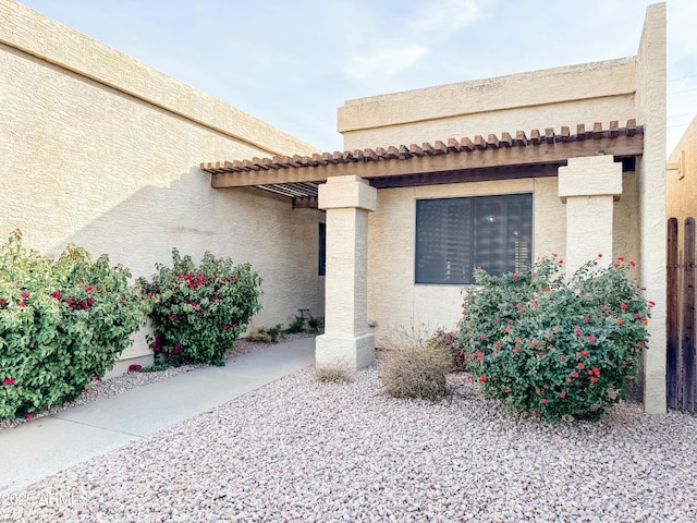 doorway to property with stucco siding