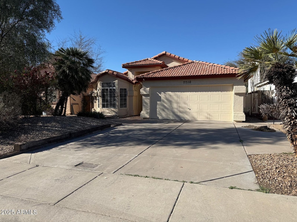 mediterranean / spanish-style home featuring a garage