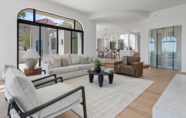 living room with a chandelier and wood finished floors
