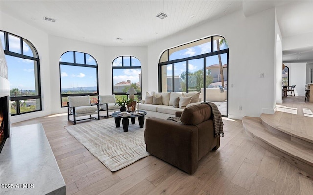 living area featuring light wood-style floors and visible vents