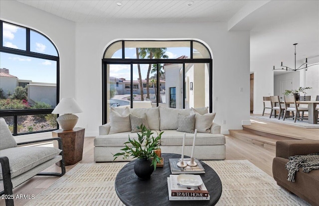 living area with a chandelier and wood finished floors