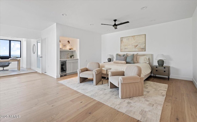 bedroom featuring wine cooler, light wood finished floors, baseboards, and recessed lighting