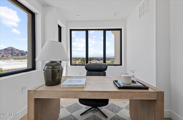 office area featuring visible vents and baseboards