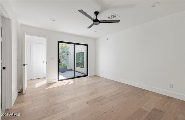 spare room with light wood-style floors, baseboards, a ceiling fan, and visible vents