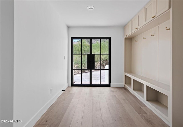 mudroom featuring baseboards, light wood finished floors, and recessed lighting