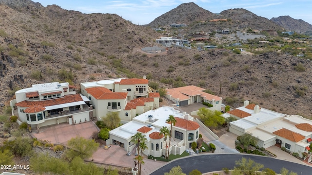 birds eye view of property featuring a mountain view, view of desert, and a residential view