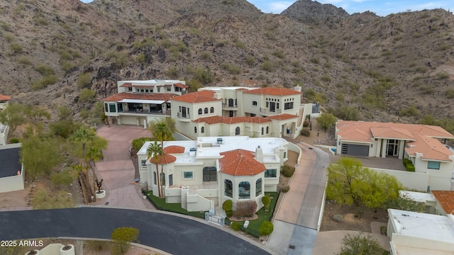 birds eye view of property with a mountain view and a desert view