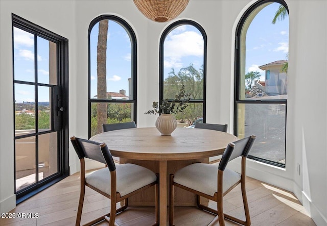 dining room featuring light wood-type flooring and baseboards