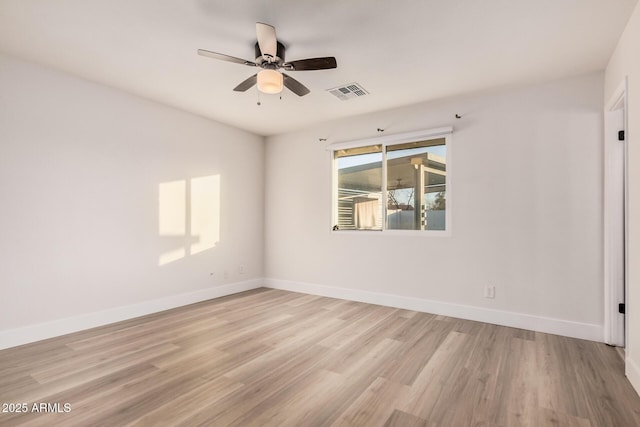 unfurnished room with a ceiling fan, baseboards, visible vents, and light wood finished floors