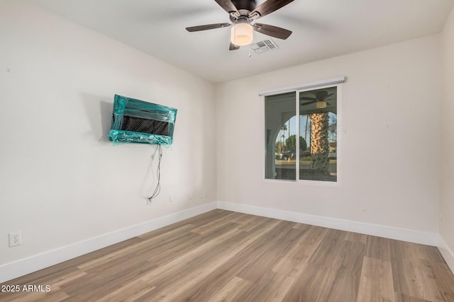 empty room featuring baseboards and wood finished floors